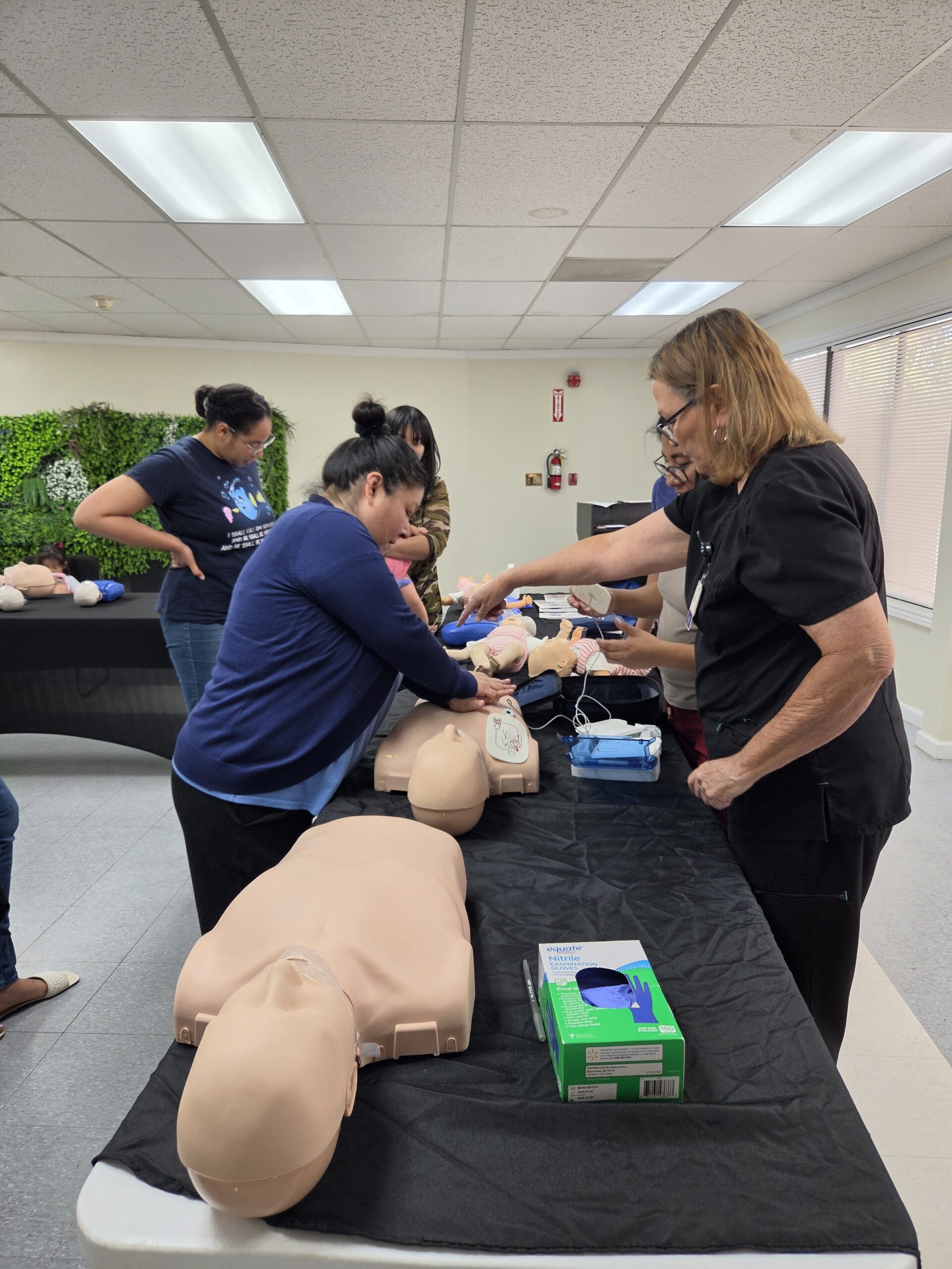 Instructor providing hands-on newborn care education