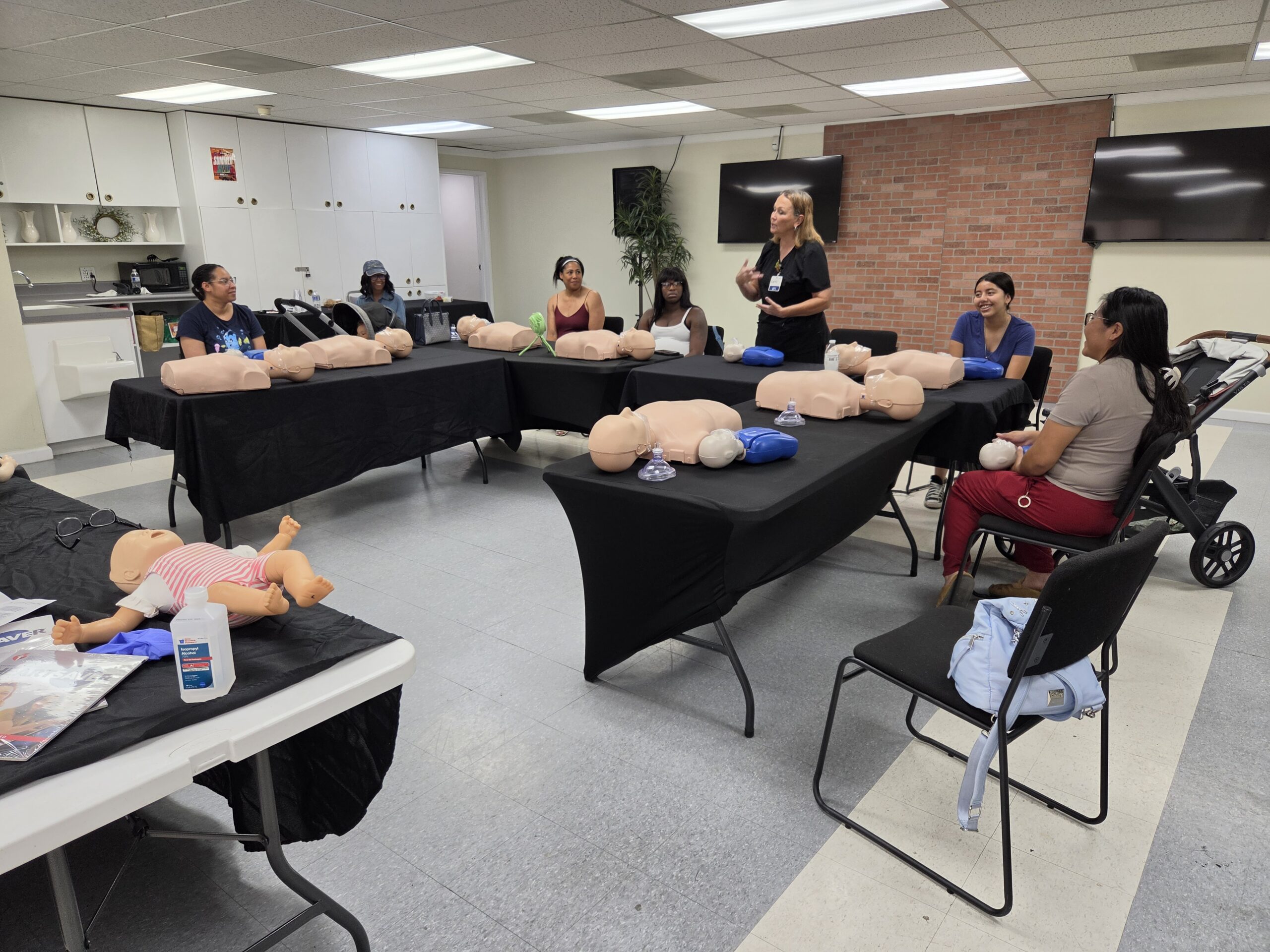 Mothers attending a hands-on maternal and infant wellness class